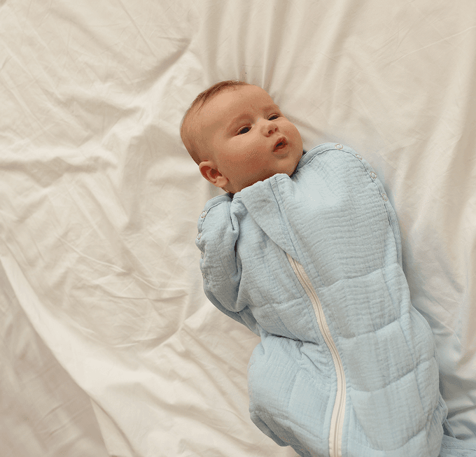 Baby swaddled in a light blue Lullaboo weighted sleeping bag